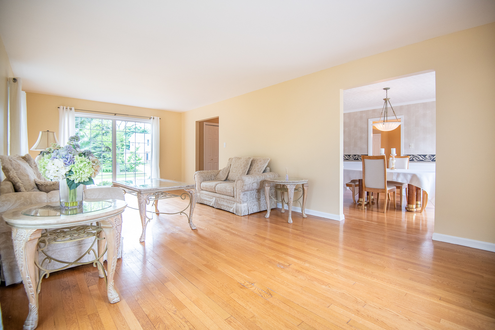 227 Country Club Drive Addison, IL 60101 - Photo 6 of 39 a living room with furniture and a table with wooden floor