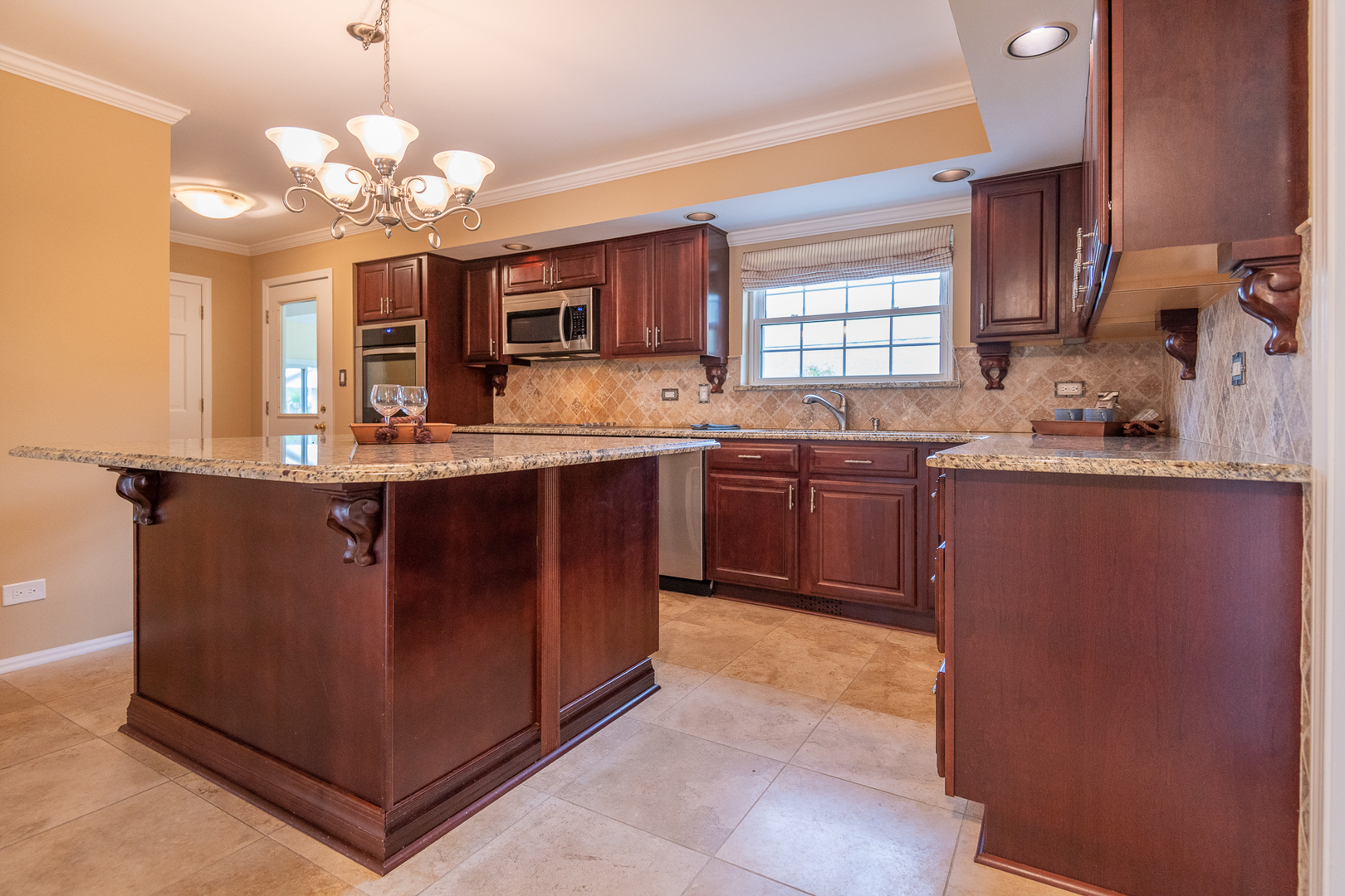 227 Country Club Drive Addison, IL 60101 - Photo 9 of 39 a kitchen with cabinets a sink and stainless steel appliances