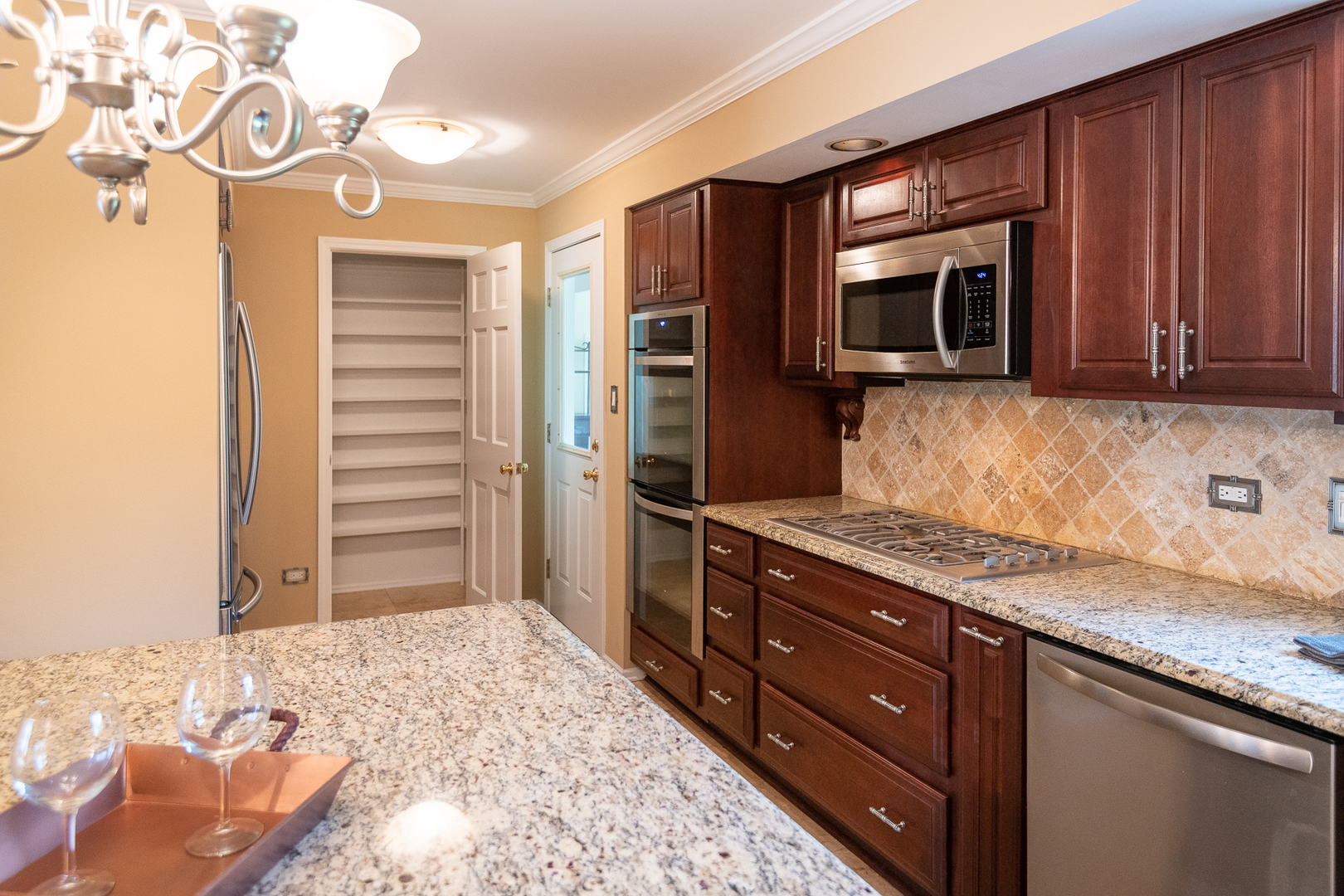 227 Country Club Drive Addison, IL 60101 - Photo 10 of 39 a kitchen with stainless steel appliances granite countertop a stove a microwave and a refrigerator