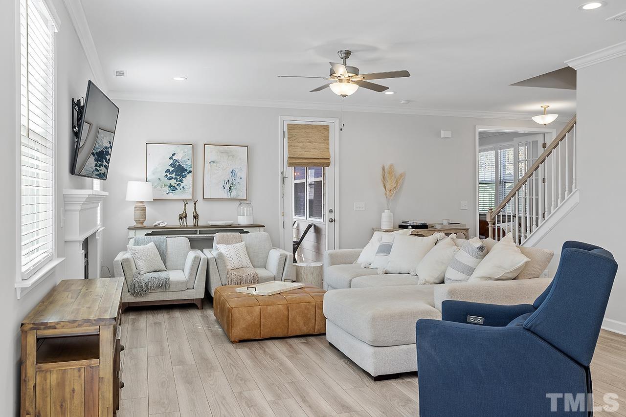 1445 Commons Ford Place Apex, NC 27539 - Photo 11 of 34 a living room with furniture and a chandelier