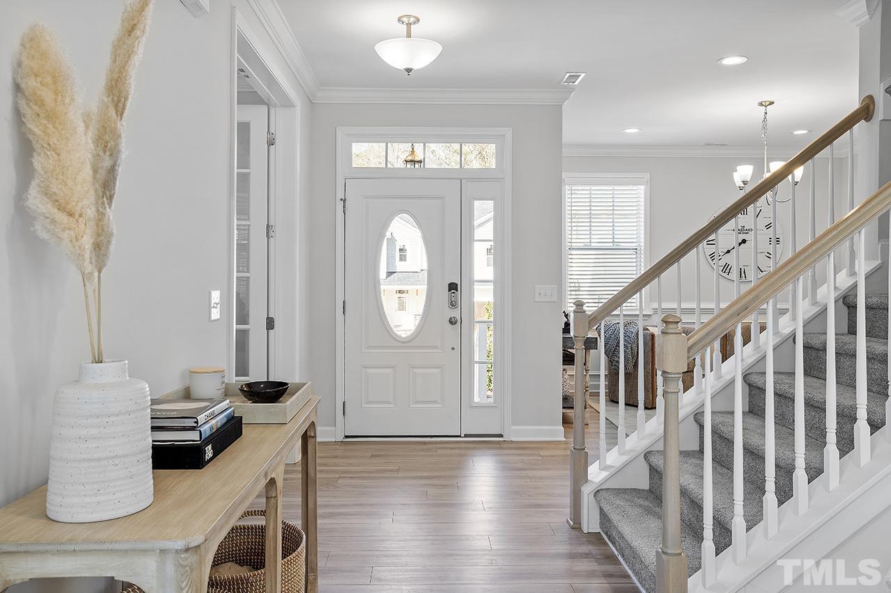 1445 Commons Ford Place Apex, NC 27539 - Photo 14 of 34 a view of entryway and hall with wooden floor