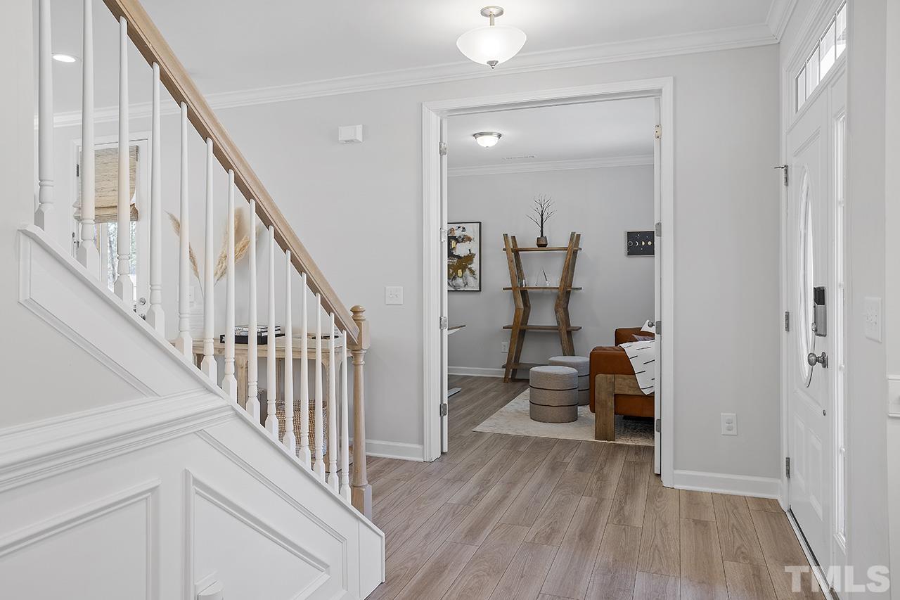 1445 Commons Ford Place Apex, NC 27539 - Photo 17 of 34 a view of a livingroom with furniture and hardwood floor