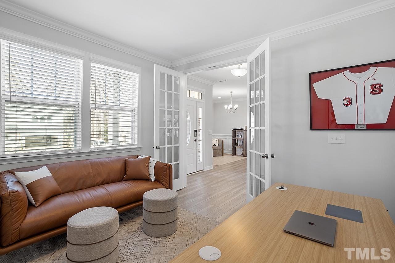 1445 Commons Ford Place Apex, NC 27539 - Photo 19 of 34 a living room with furniture and a large window