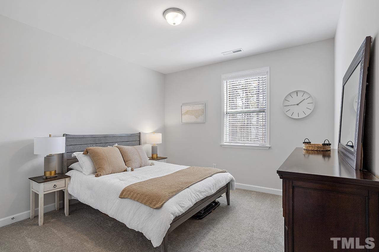 1445 Commons Ford Place Apex, NC 27539 - Photo 26 of 34 a bedroom with a bed and a desk