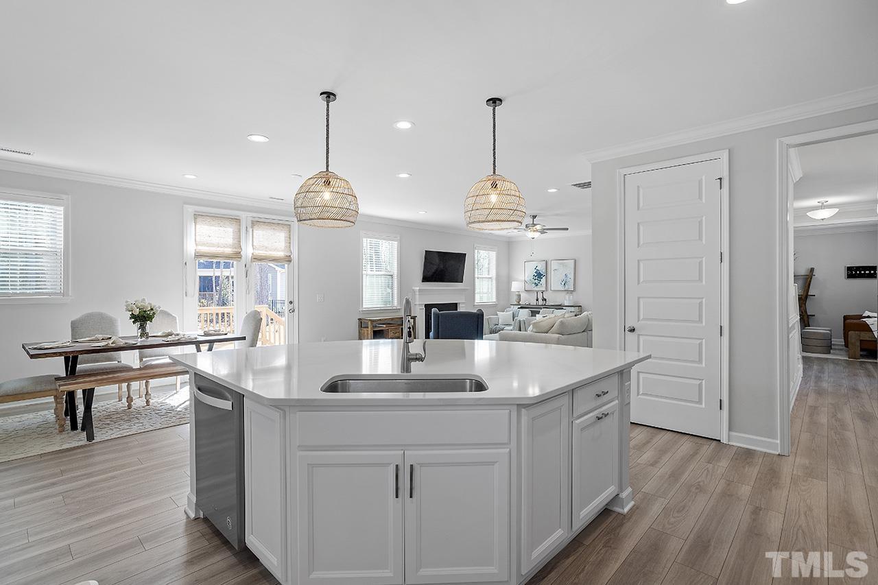 1445 Commons Ford Place Apex, NC 27539 - Photo 4 of 34 a view of living room kitchen island and a window