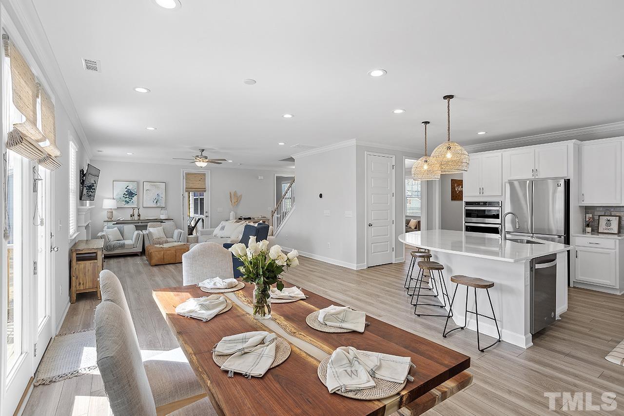 1445 Commons Ford Place Apex, NC 27539 - Photo 9 of 34 a large kitchen with a table and chairs