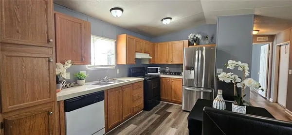 a kitchen with a sink stove and refrigerator