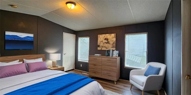 a spacious bedroom with a bed and a couch