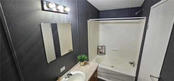 a bathroom with a sink and mirror