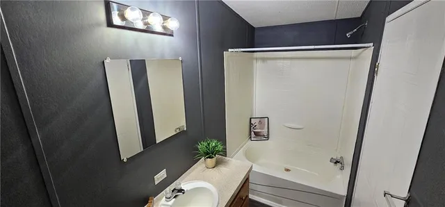 a bathroom with a sink and mirror
