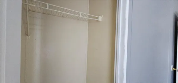 a bathroom with a toilet and a mirror