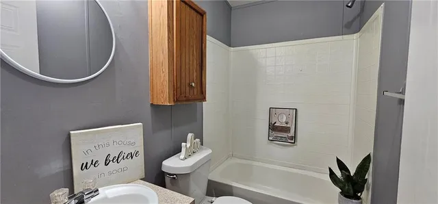 a bathroom with a mirror and a sink
