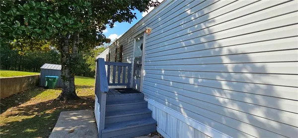 a view of a patio with table and chairs with wooden fence and plants