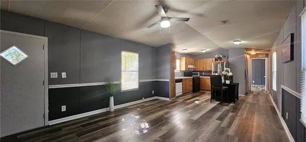 a view of a living room with furniture and a flat screen tv