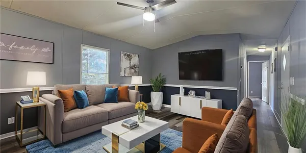 a living room with furniture and a flat screen tv