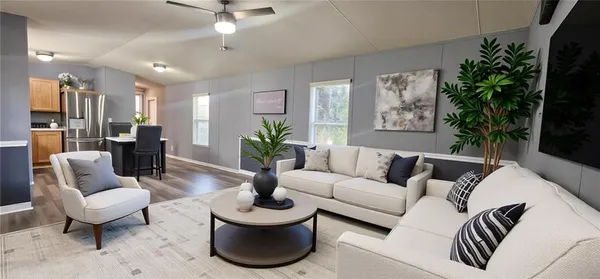 a living room with furniture potted plant and a window