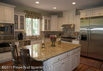 875 Sheffield Road Shavertown, PA 18708 - Photo 6 of 17 a kitchen with stainless steel appliances granite countertop a sink refrigerator and cabinets