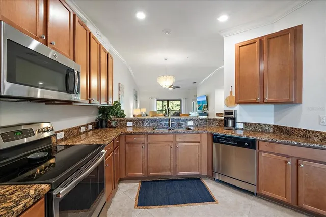 a kitchen with stainless steel appliances a sink stove and microwave