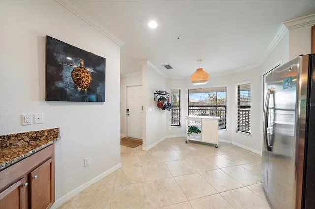 a view of a kitchen with furniture and refrigerator