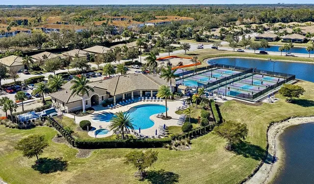 an aerial view of a house with a swimming pool yard and outdoor seating