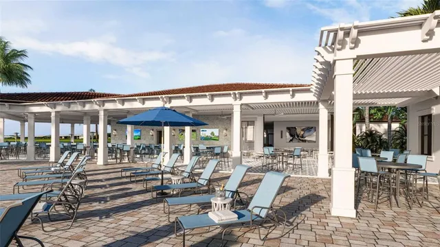 a view of a patio with table and chairs under an umbrella