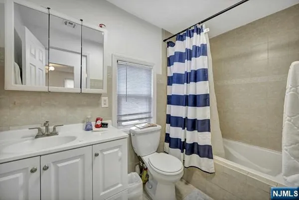 a bathroom with a sink toilet and a mirror