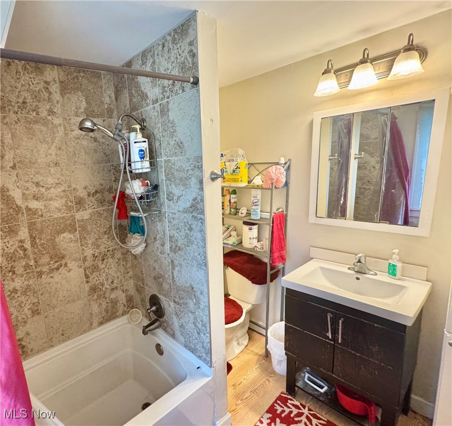 4406 Bayard Road Cleveland, OH 44121 - Photo 9 of 10 Full bath featuring shower combination, vanity, and wood finished floors