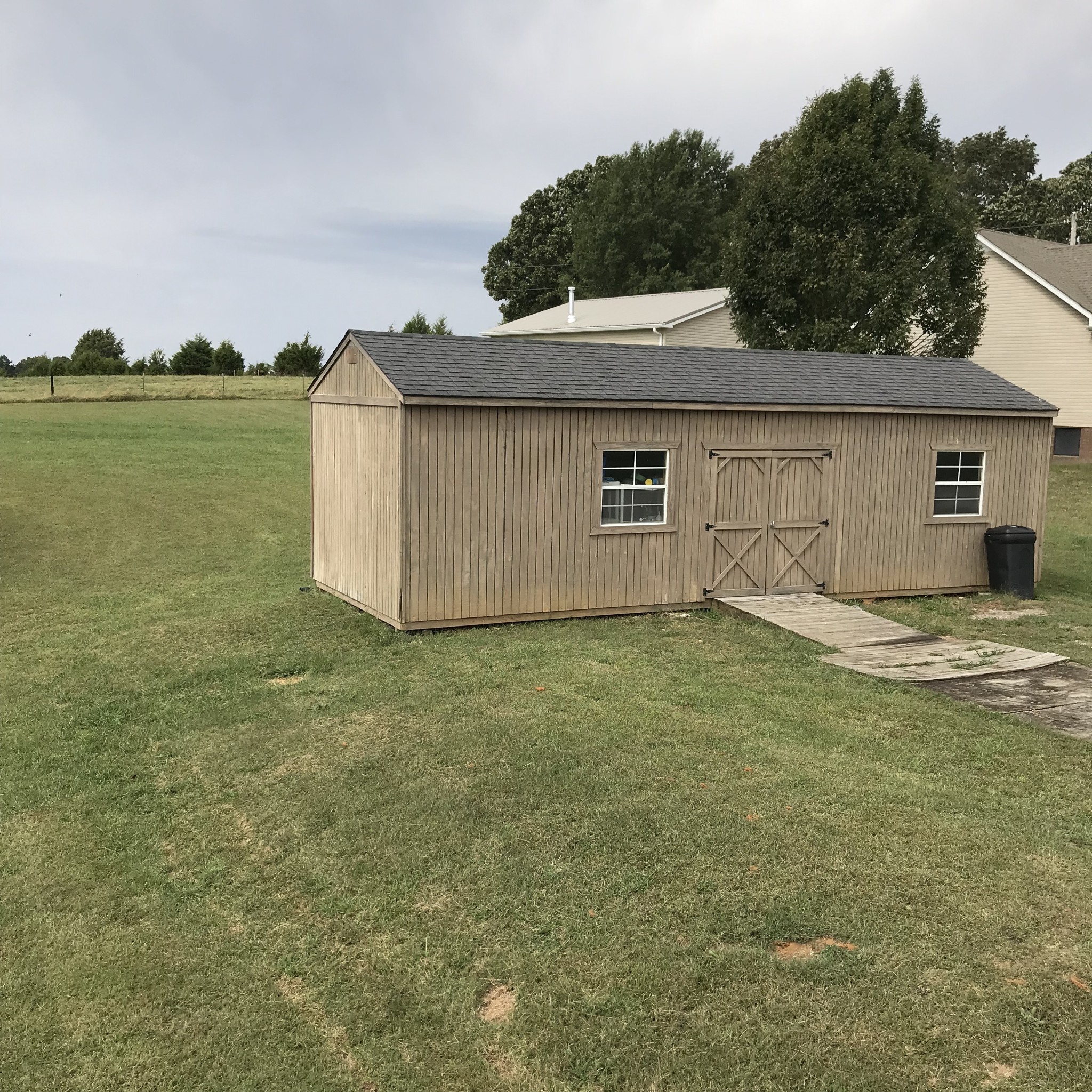 347 Freeland Road Portland, TN 37148 - Photo 11 of 13 a backyard of a house with lots of green space and fog