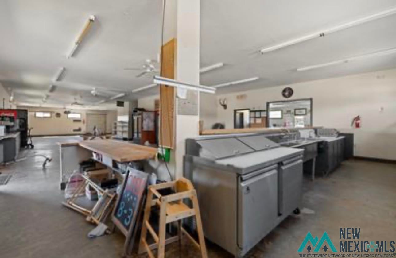371 Candy Kitchen Road Candy Kitchen, NM 87357 - Photo 46 of 49 Spacious interior featuring concrete flooring, fluorescent lighting, and multiple ceiling fans
