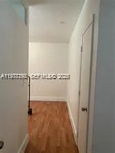 an empty room with wooden floor