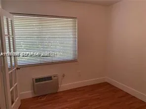a bathroom with a shower a toilet and a exposed radiator