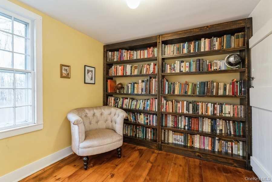 1141 Beekman Road Hopewell Junction, NY 12533 - Photo 25 of 36 a living room with furniture and a book shelf