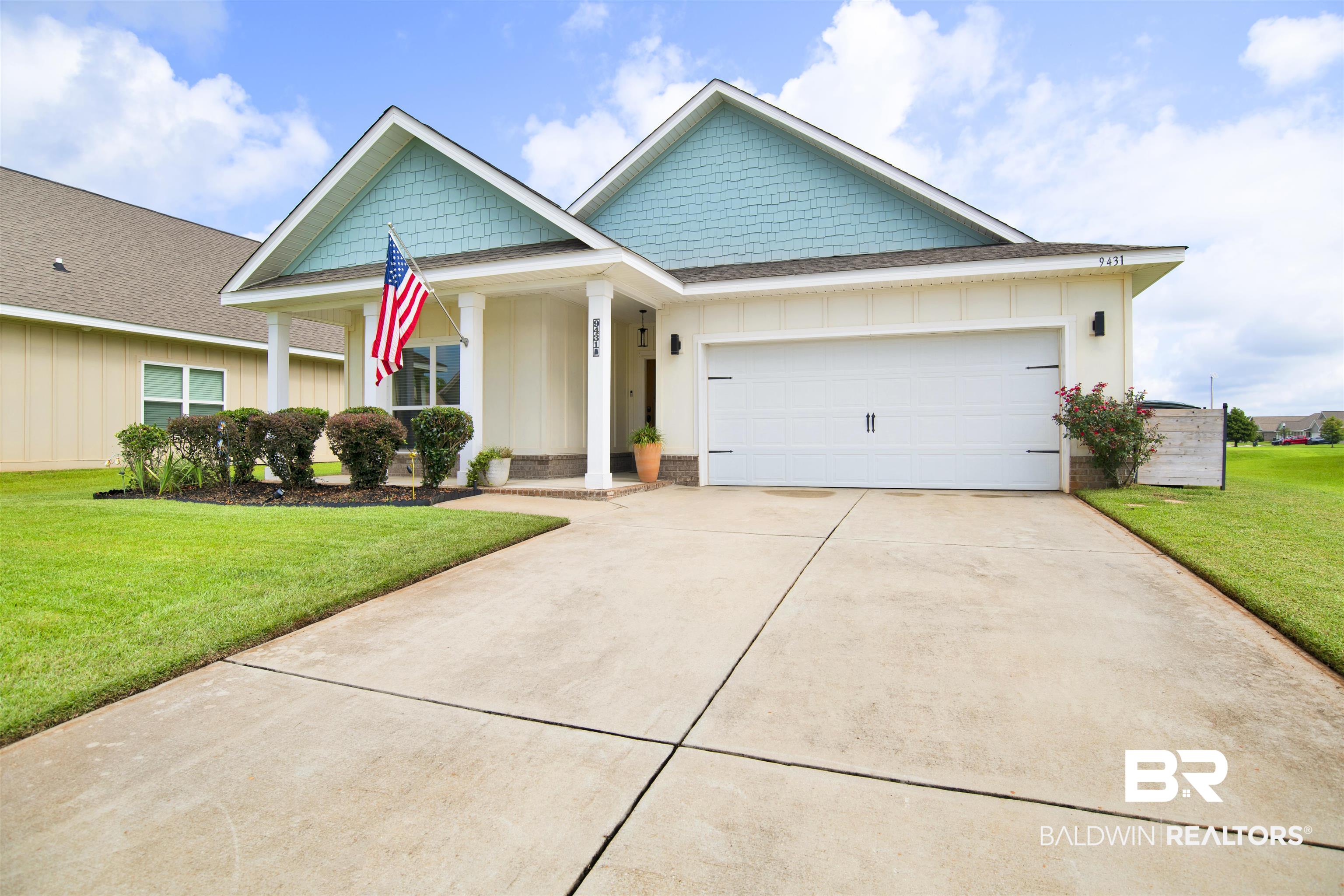 9431 Swan Point Road Daphne, AL 36526 - Photo 1 of 35 Craftsman house featuring board and batten siding, roof with shingles, a front lawn, an attached garage, and driveway