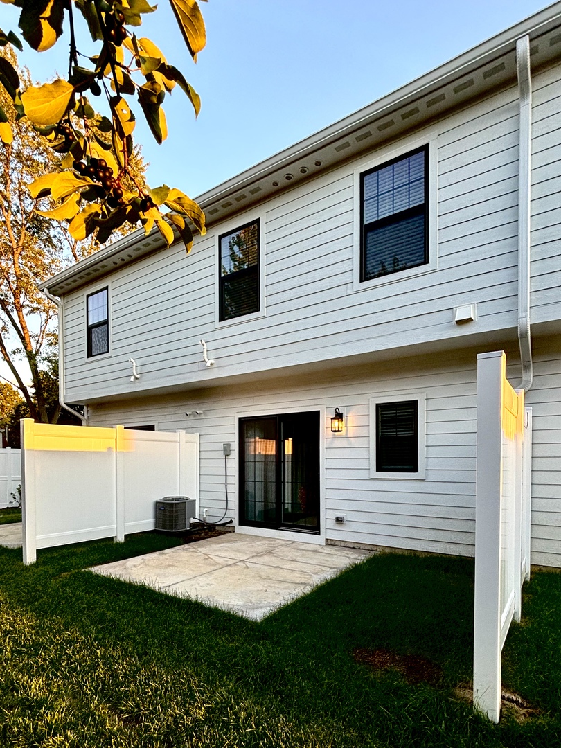 1432 North Naperville Wheaton Road, Unit 114 Naperville, IL 60563 - Photo 12 of 15 a front view of a house with a yard and garage