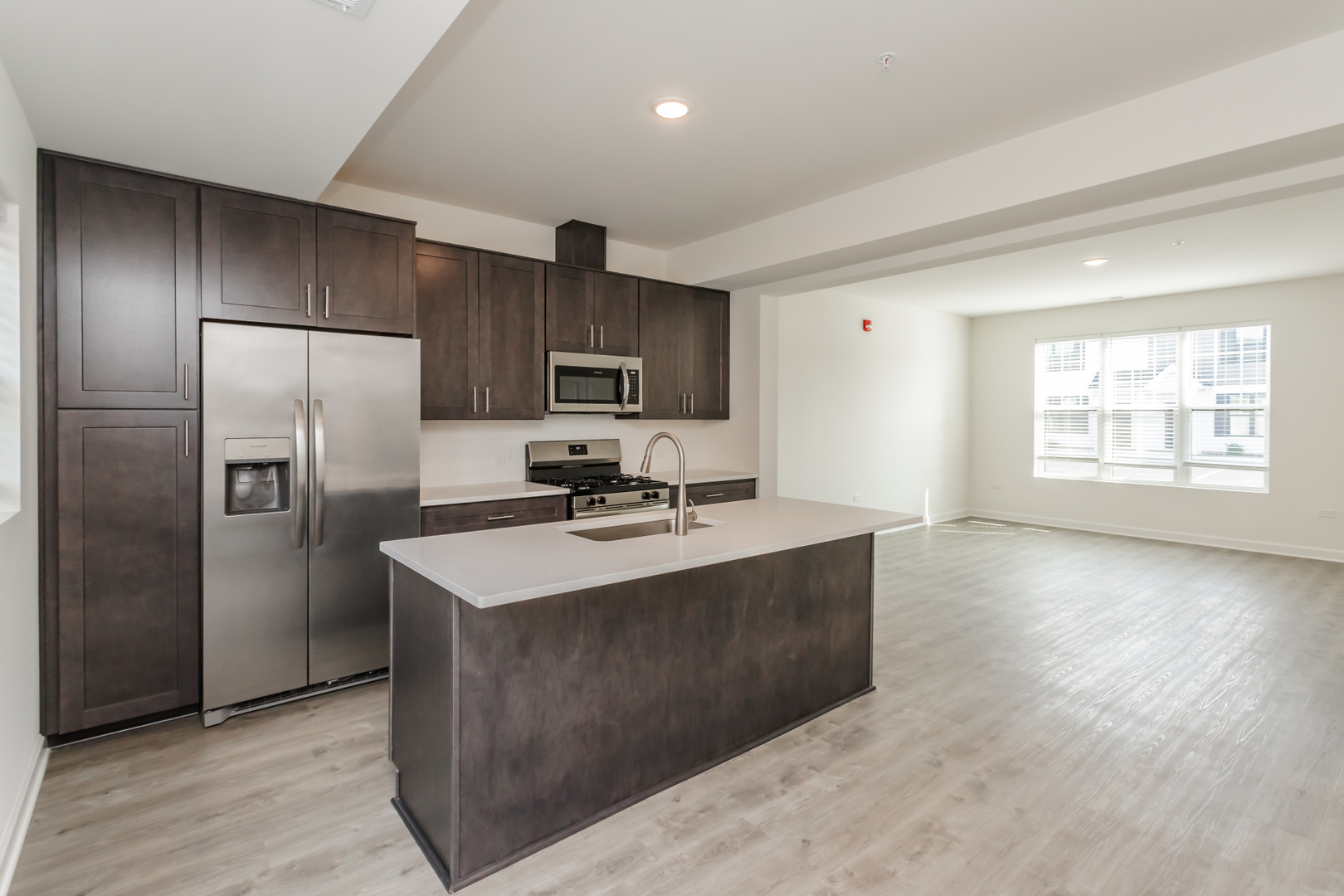 1432 North Naperville Wheaton Road, Unit 114 Naperville, IL 60563 - Photo 4 of 15 a kitchen with stainless steel appliances granite countertop a sink stove and refrigerator