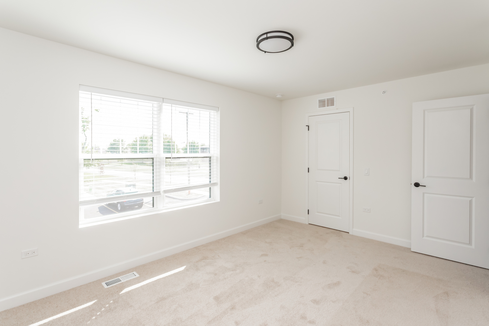 1432 North Naperville Wheaton Road, Unit 114 Naperville, IL 60563 - Photo 10 of 15 a view of an empty room with a window