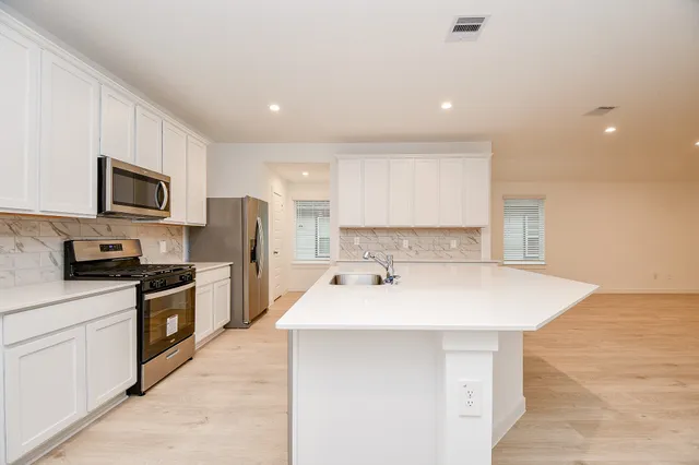 a bathroom with a sink vanity and mirror