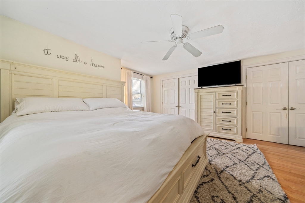 55 Running Brook Road Boston, MA 02132 - Photo 19 of 32 a bedroom with a bed and a flat screen tv