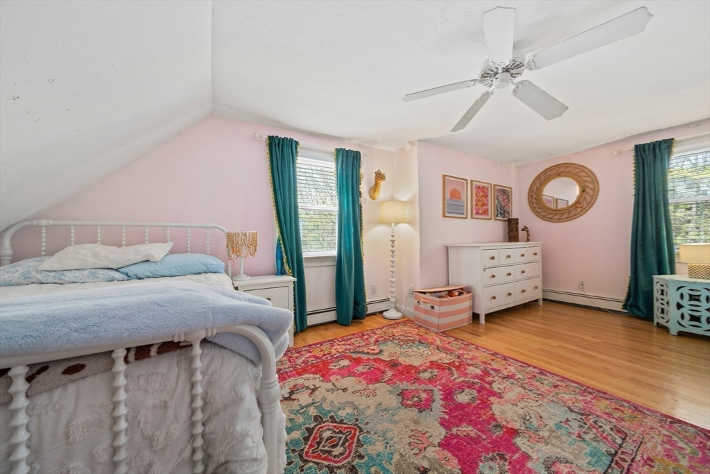 55 Running Brook Road Boston, MA 02132 - Photo 21 of 32 a bedroom with a bed and a chandelier