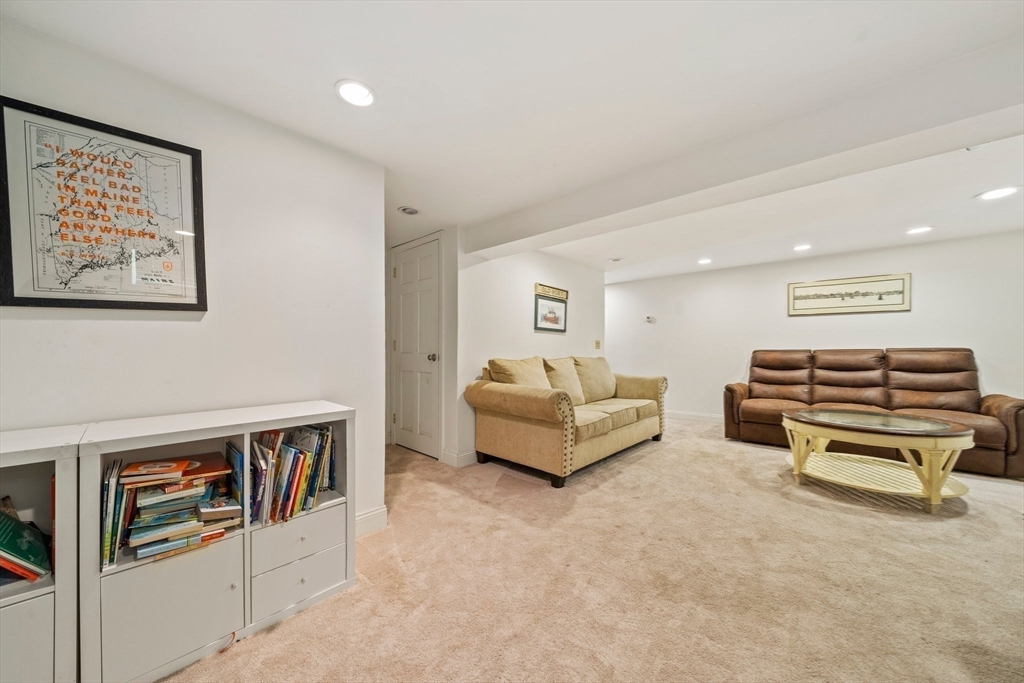 55 Running Brook Road Boston, MA 02132 - Photo 24 of 32 a living room with furniture and a flat screen tv