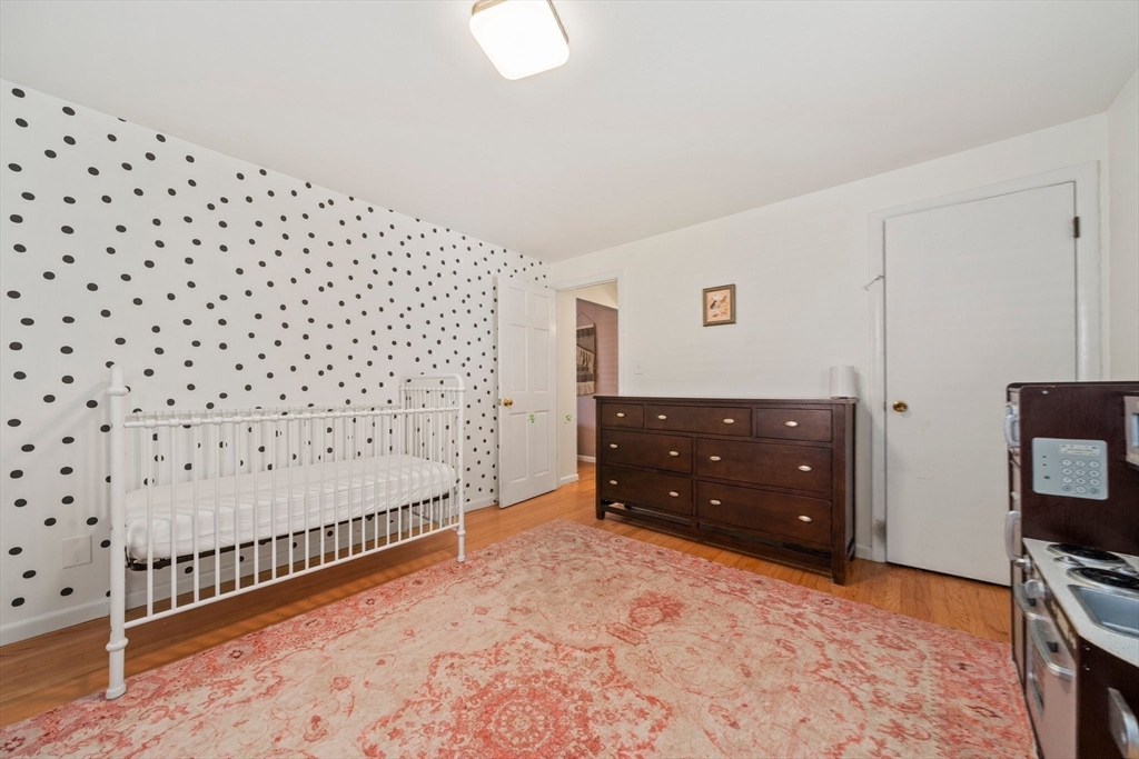 55 Running Brook Road Boston, MA 02132 - Photo 25 of 32 a bedroom with a bed and a tv on the table