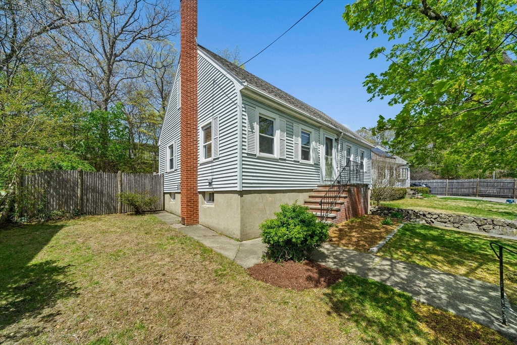 55 Running Brook Road Boston, MA 02132 - Photo 3 of 32 a backyard of a house with lots of green space