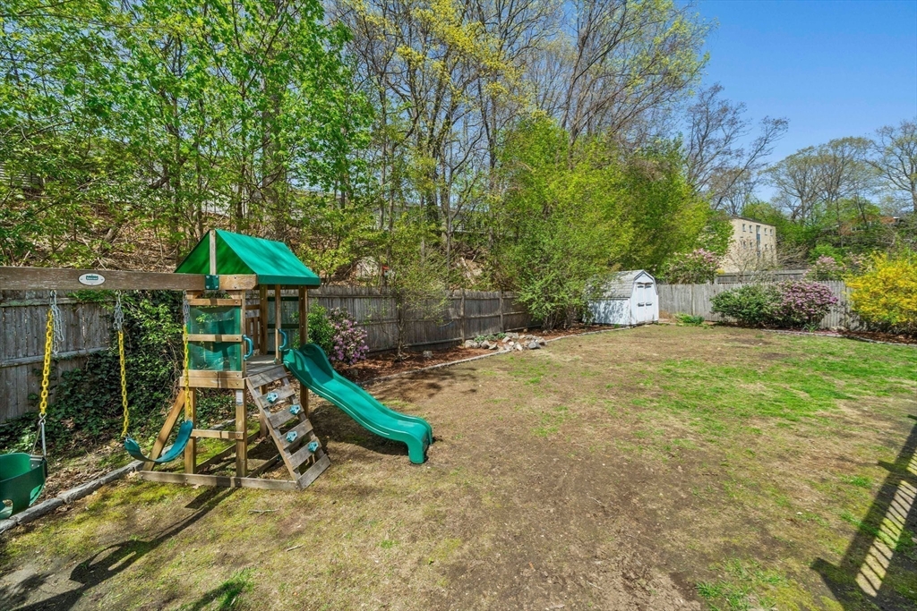 55 Running Brook Road Boston, MA 02132 - Photo 6 of 32 a backyard of a house with table and chairs