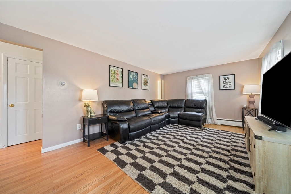 55 Running Brook Road Boston, MA 02132 - Photo 7 of 32 a bedroom with furniture and a flat screen tv