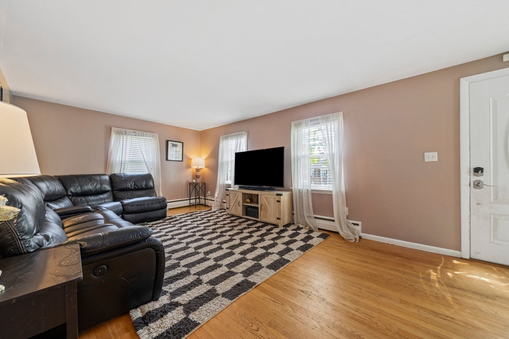 55 Running Brook Road Boston, MA 02132 - Photo 9 of 32 a living room with furniture and a flat screen tv