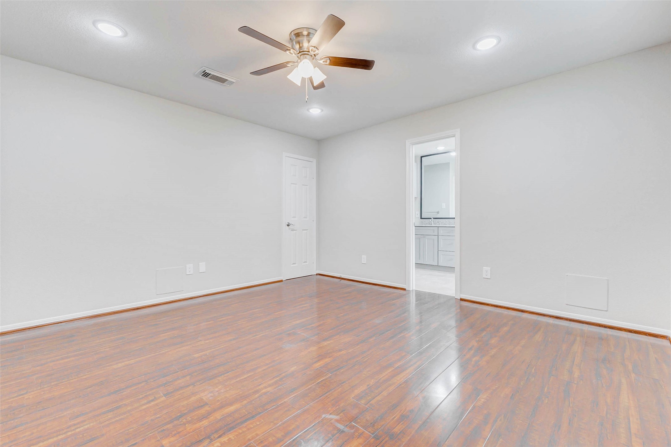 2410 Clear Ridge Drive Houston, TX 77339 - Photo 15 of 24 an empty room with wooden floor and a ceiling fan