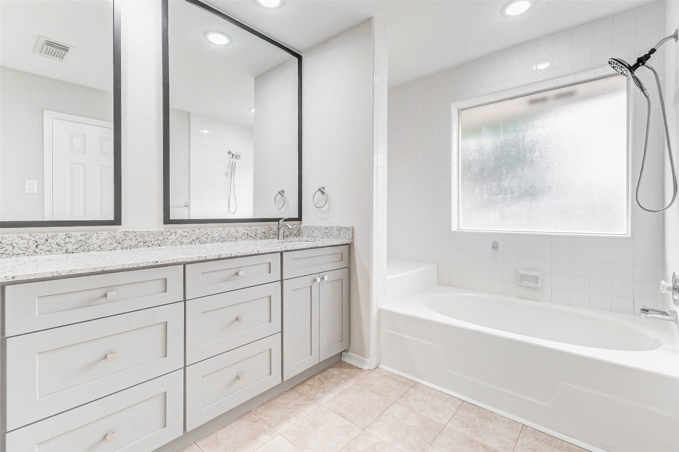 2410 Clear Ridge Drive Houston, TX 77339 - Photo 17 of 24 a bathroom with a bathtub a double vanity sink and mirror
