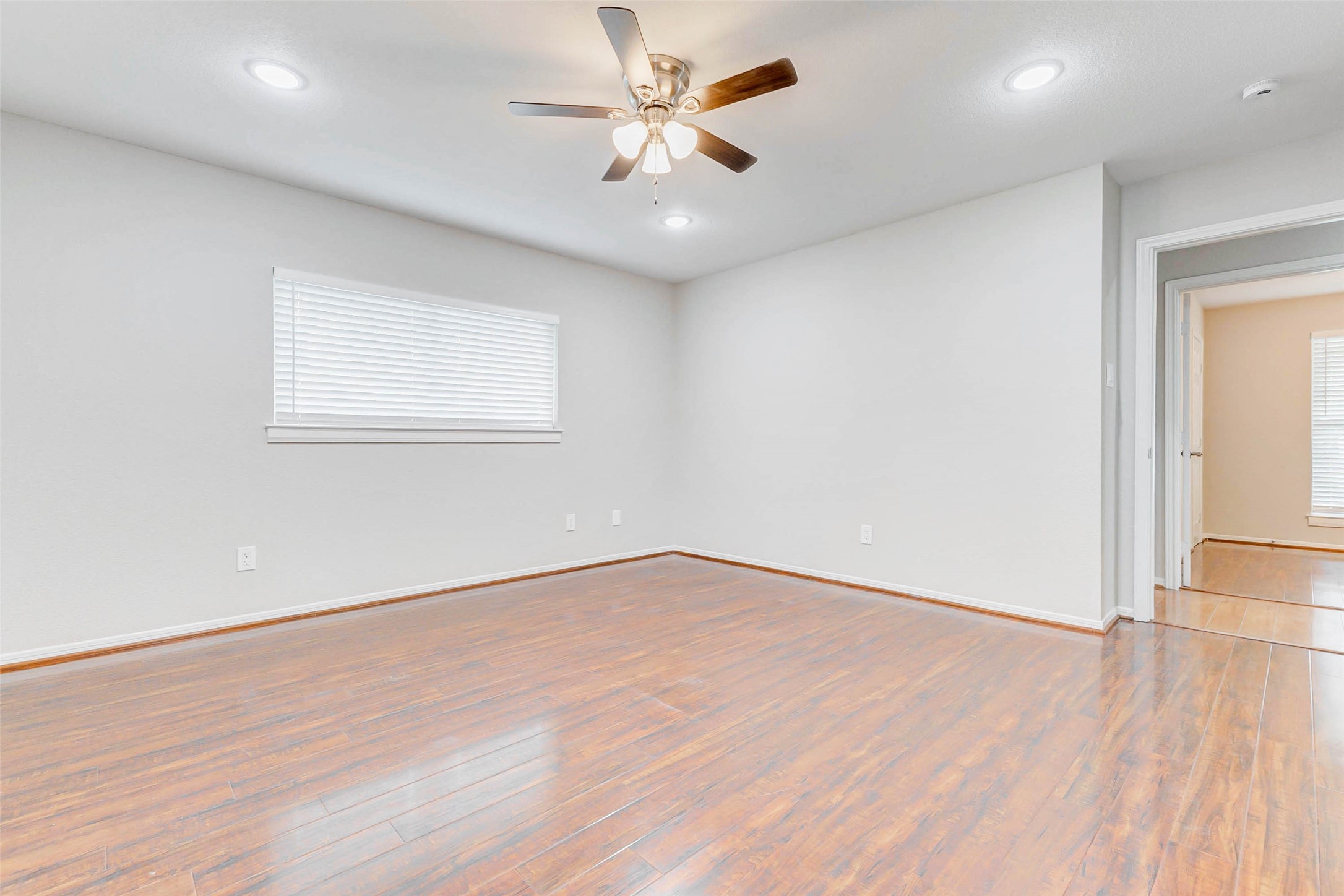 2410 Clear Ridge Drive Houston, TX 77339 - Photo 18 of 24 an empty room with wooden floor and windows
