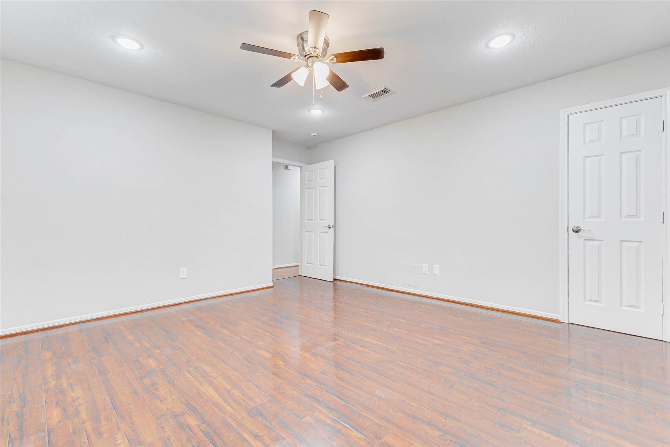 2410 Clear Ridge Drive Houston, TX 77339 - Photo 20 of 24 an empty room with wooden floor and windows