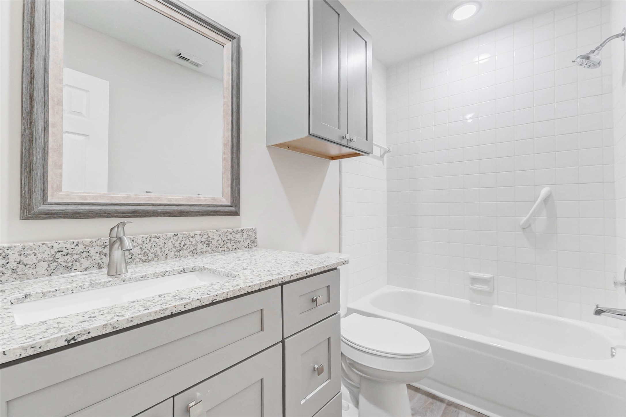 2410 Clear Ridge Drive Houston, TX 77339 - Photo 21 of 24 a bathroom with a granite countertop sink toilet and shower